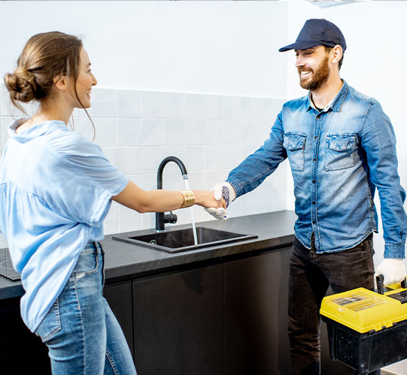 A happy client shaking hands the plumber