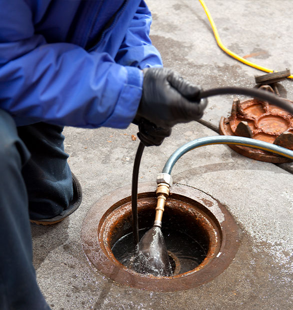 photo of plumber checking the sewer line