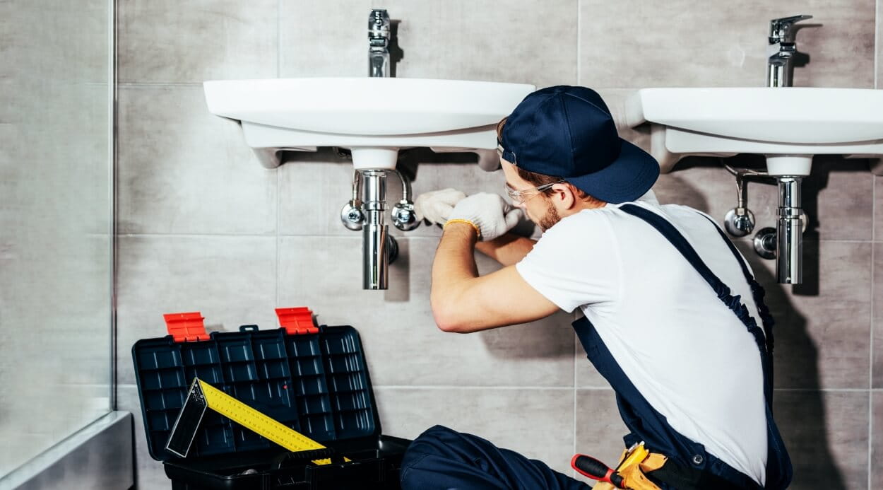 Photo of a plumber fixing a broken sink
